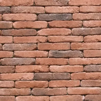 Close-up of rustic reclaimed brick wall texture in warm earth tones